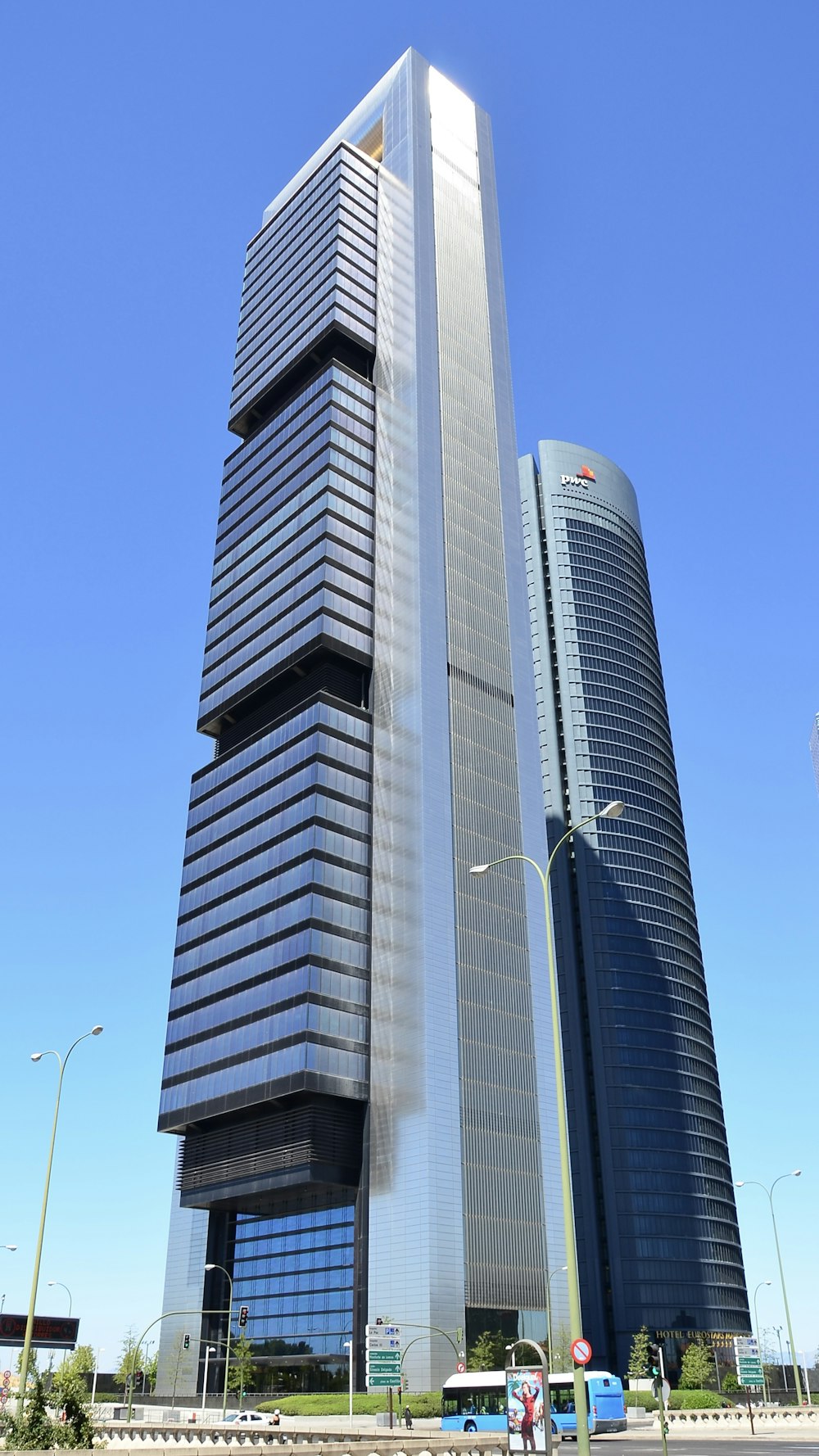 a very tall building sitting in the middle of a street