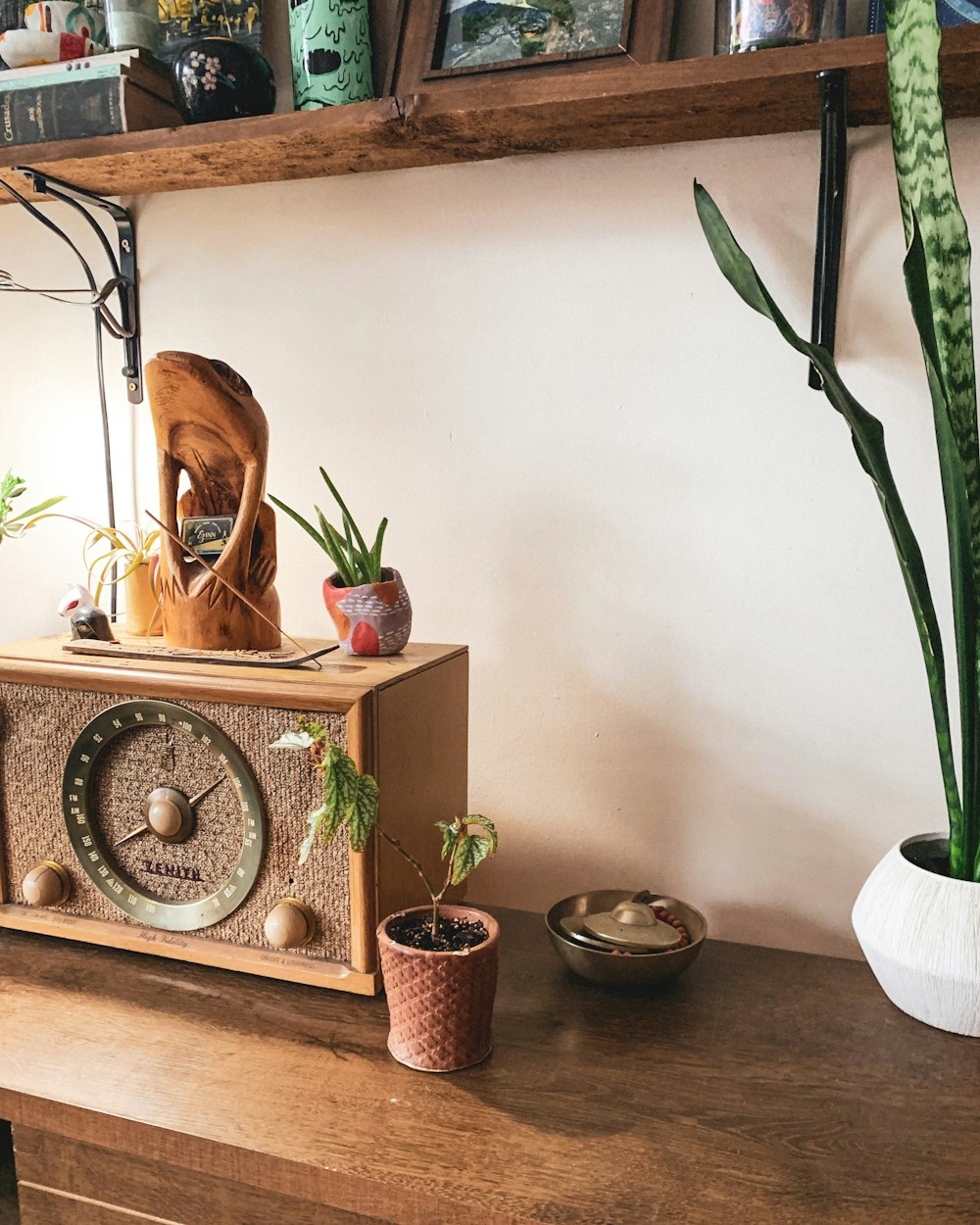 a wooden clock sitting on top of a wooden table