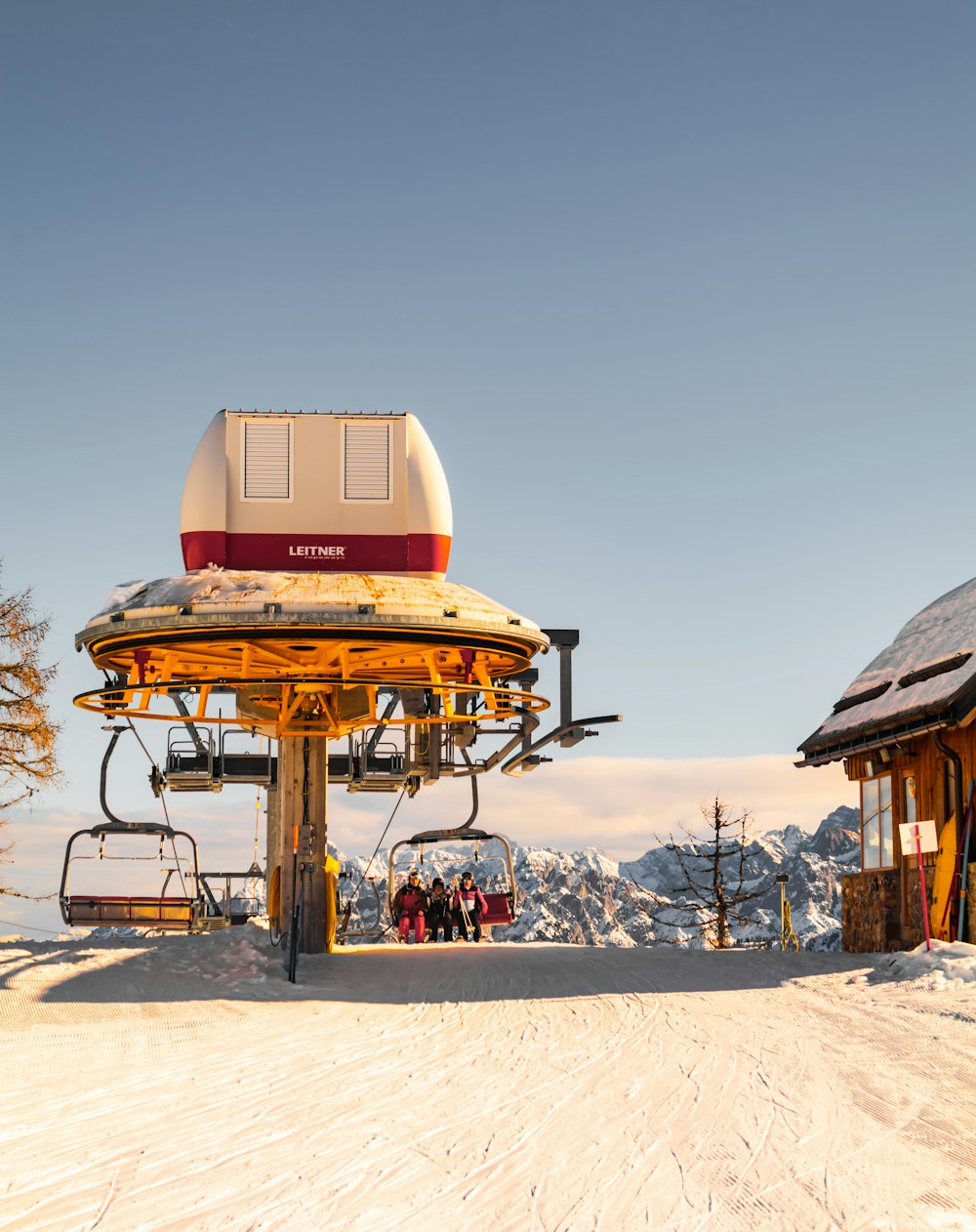 a ski lift sitting on top of a snow covered slope