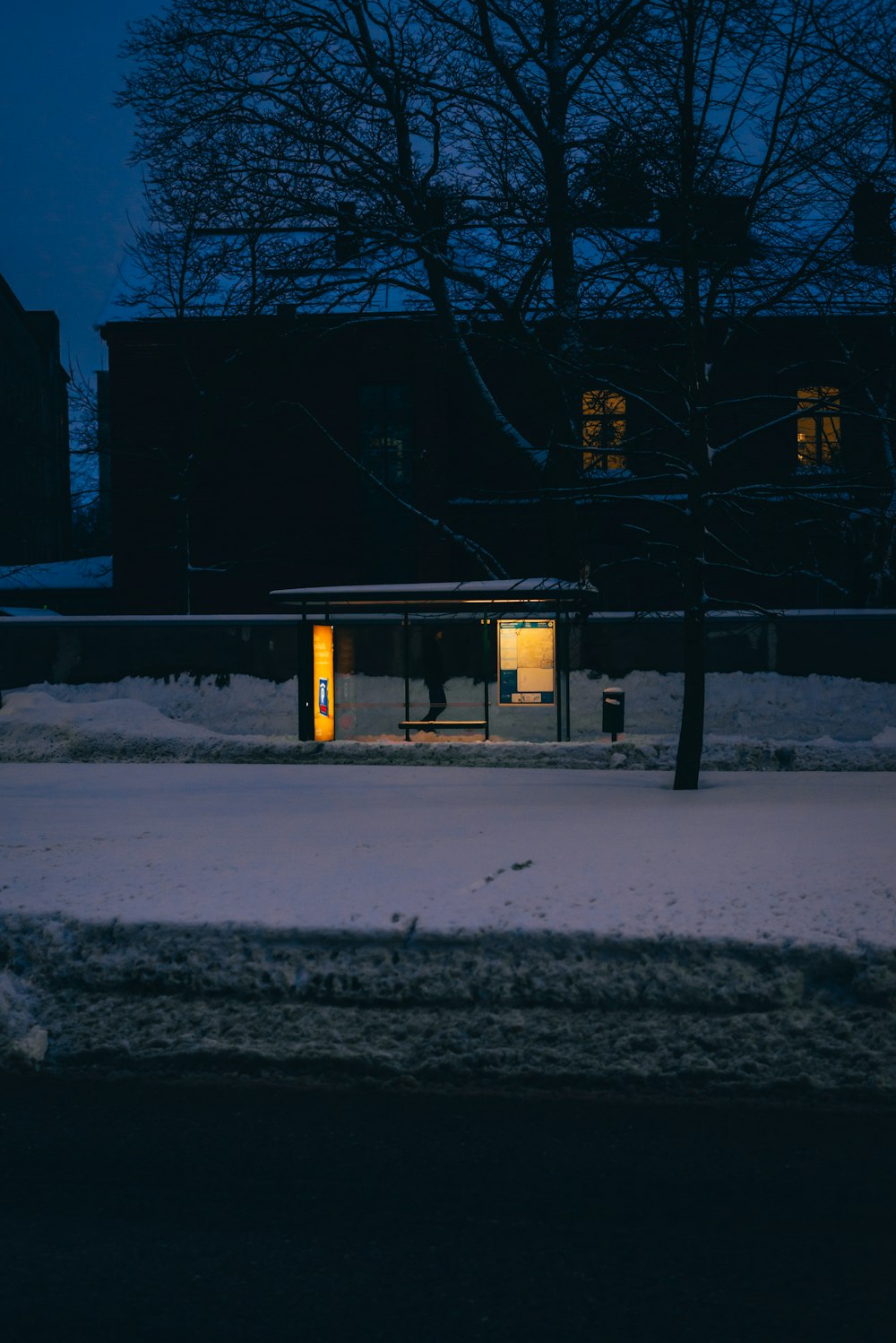 a building that is lit up at night in the snow