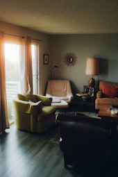 a living room filled with furniture and a large window