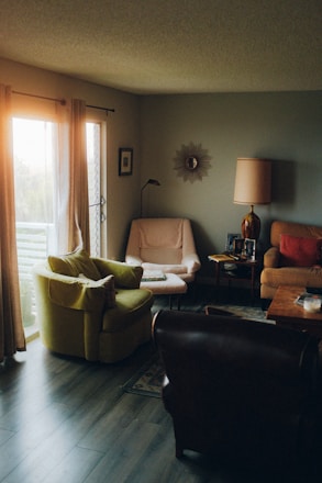 a living room filled with furniture and a large window