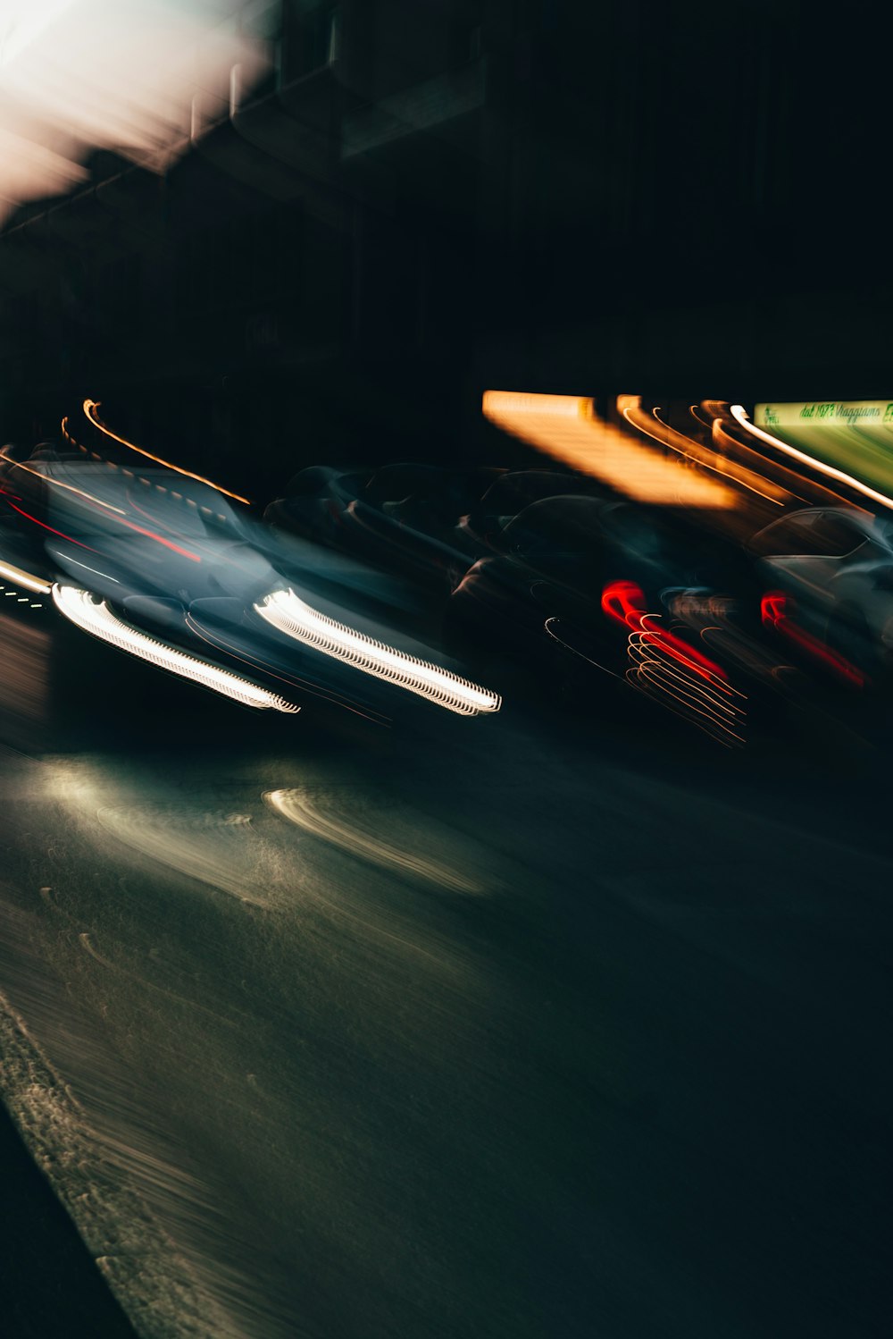 a blurry photo of cars driving down a street