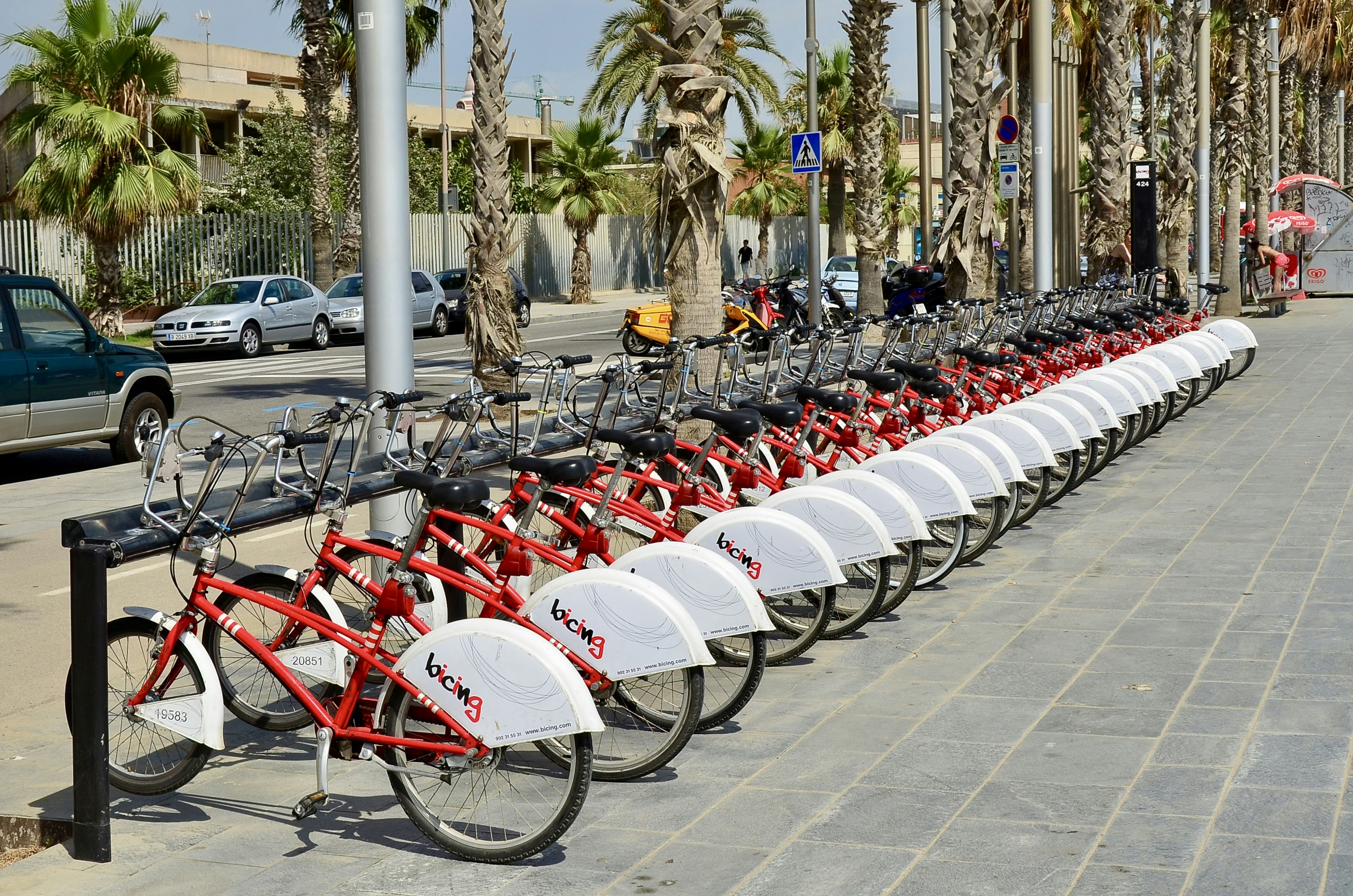 a row of red and white bicycles parked next to each other