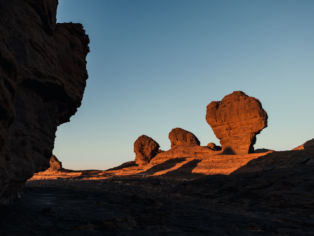 a large rock formation in the middle of a desert