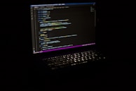 a laptop computer sitting on top of a table