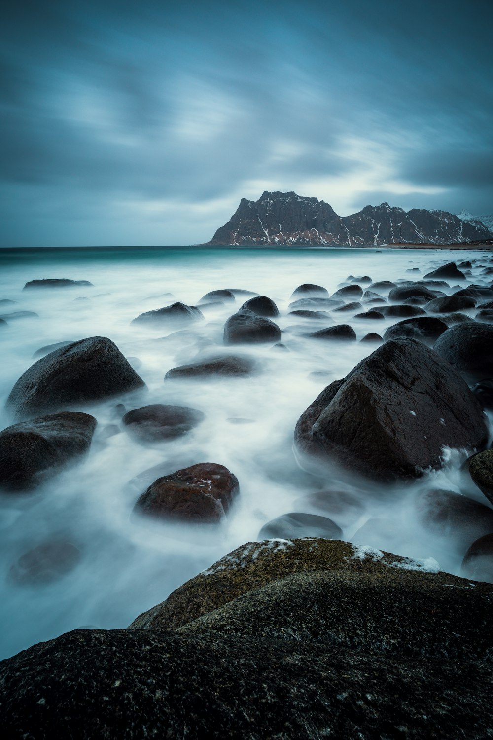 a group of rocks sitting on top of a beach