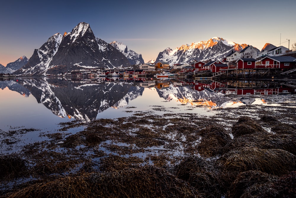 the mountains are reflected in the still water of the lake