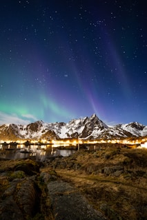 the aurora lights shine brightly over a mountain range