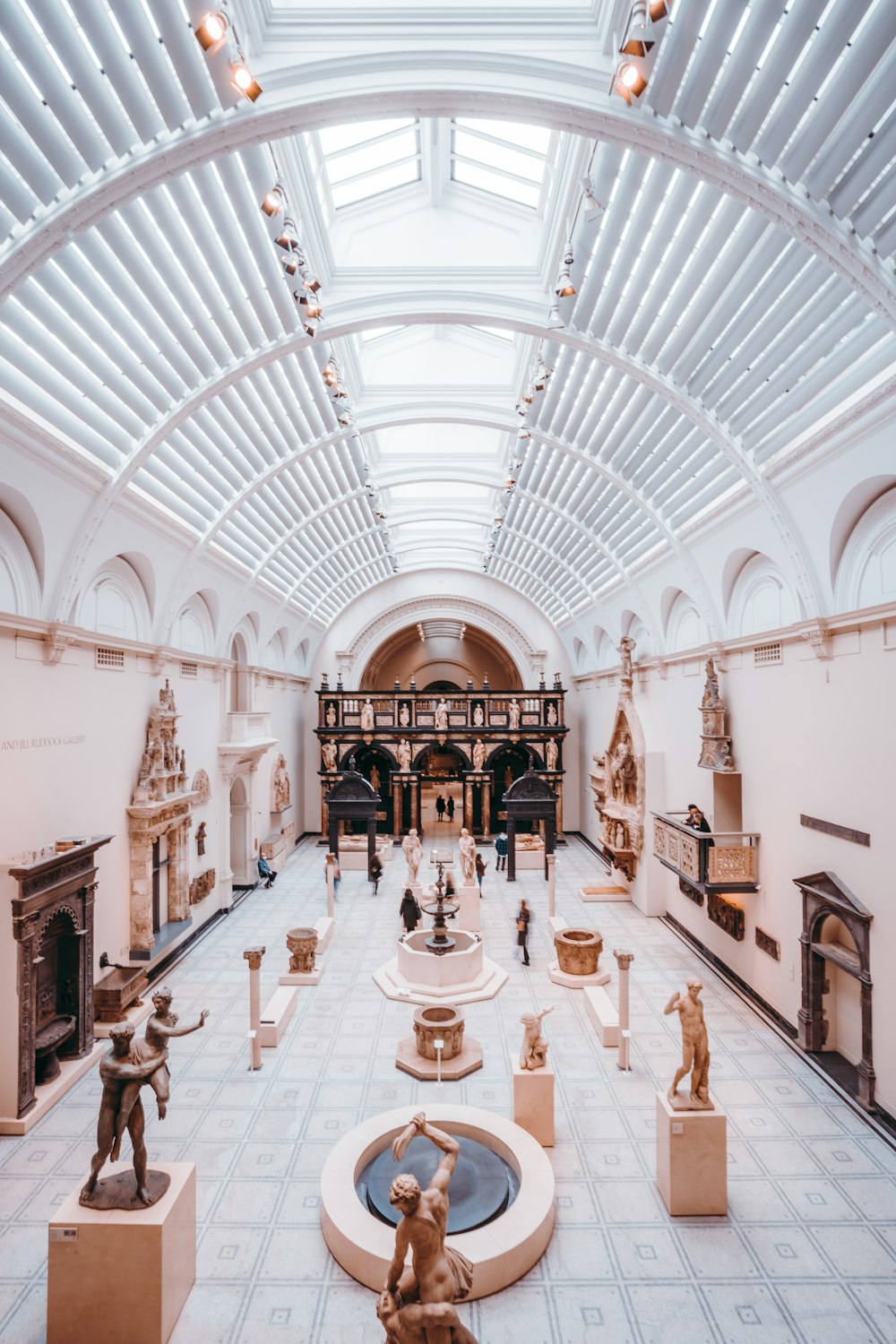 a large room filled with statues and a skylight