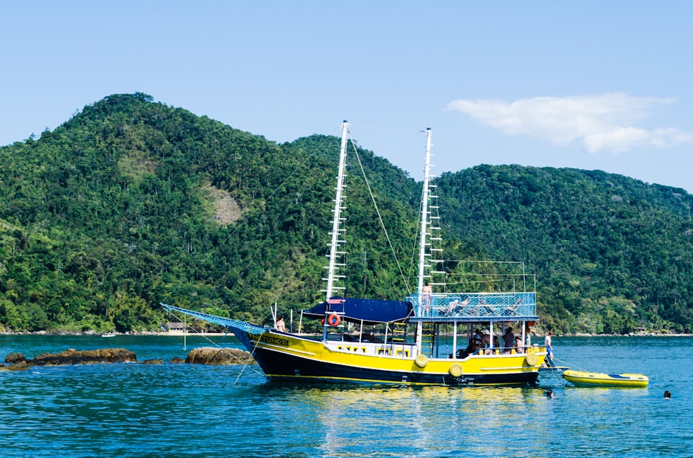 a yellow boat floating on top of a body of water