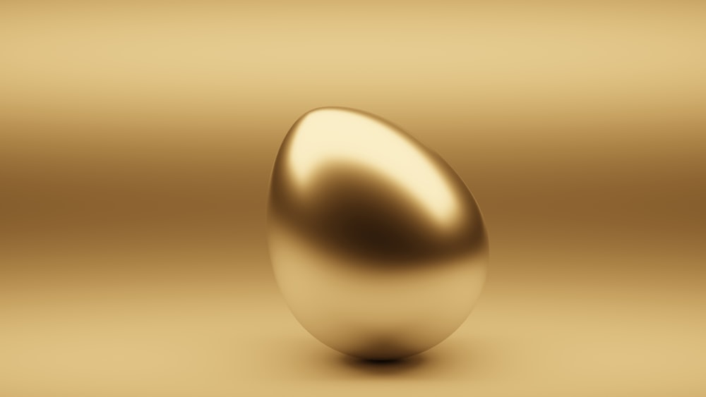 Un huevo dorado brillante sobre un fondo dorado
