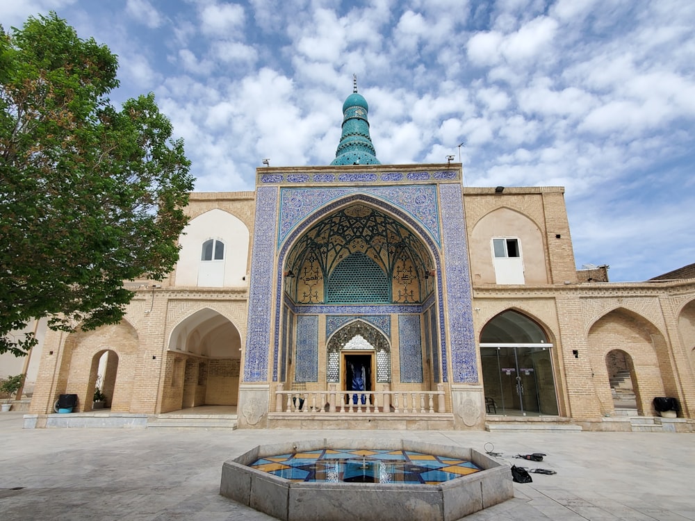 a large building with a fountain in front of it