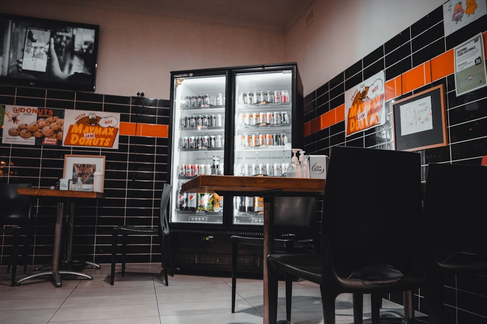 an empty restaurant with a refrigerator full of drinks