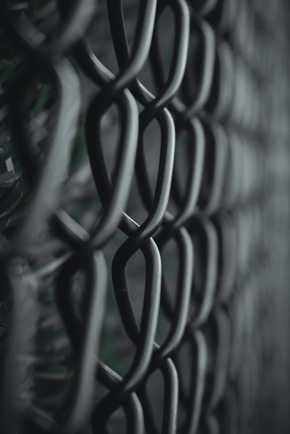 a black and white photo of a chain link fence