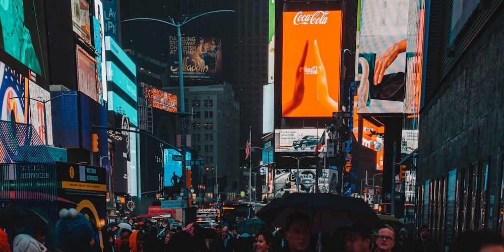 a group of people walking down a street next to tall buildings