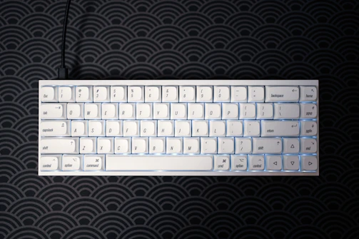 Compact Bluetooth keyboard with backlit keys on a clean white surface.