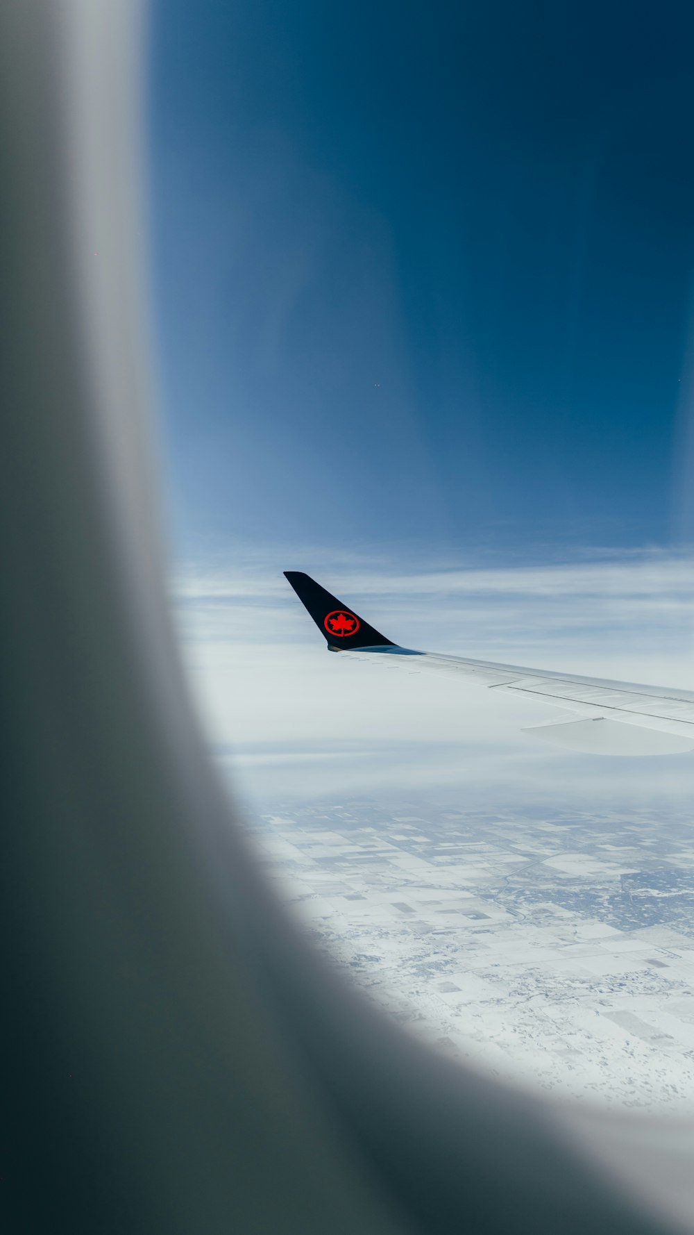 a view of the wing of an airplane in the sky