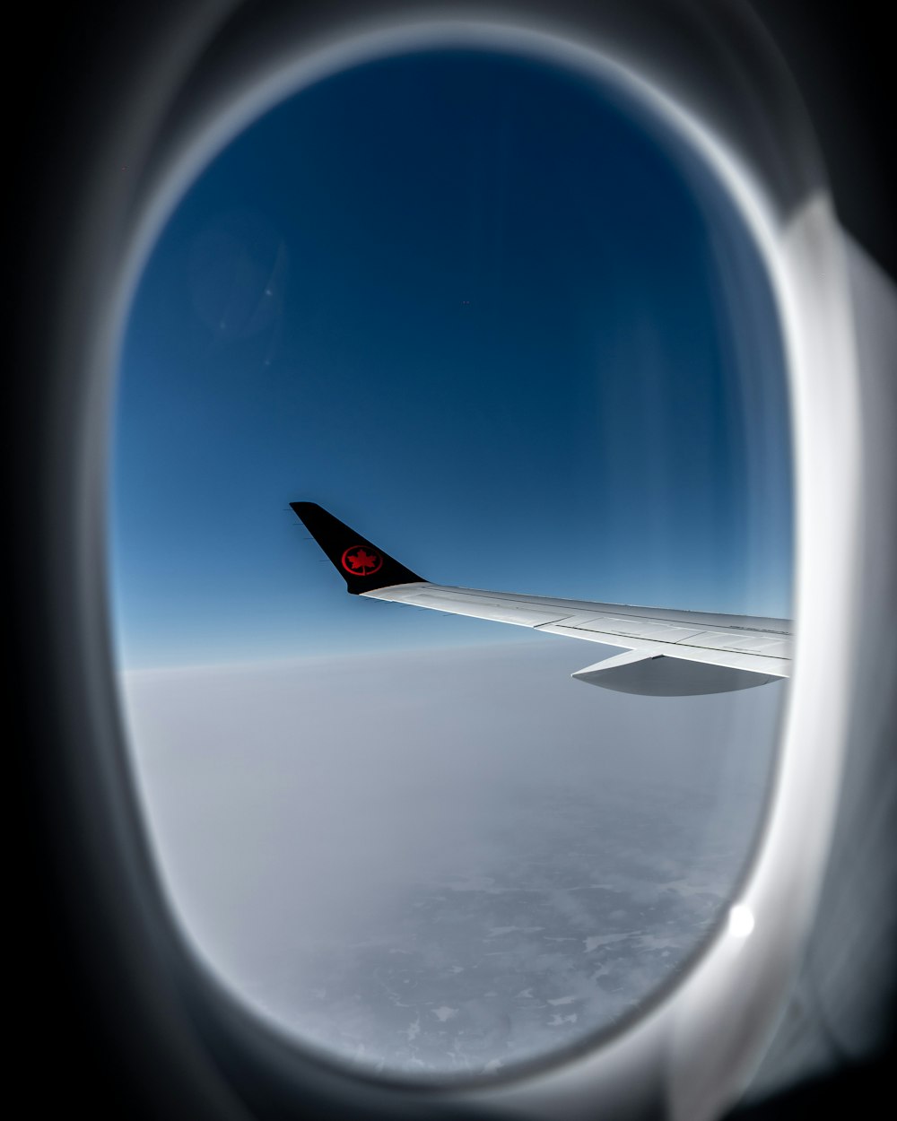 a view of the wing of an airplane in the sky