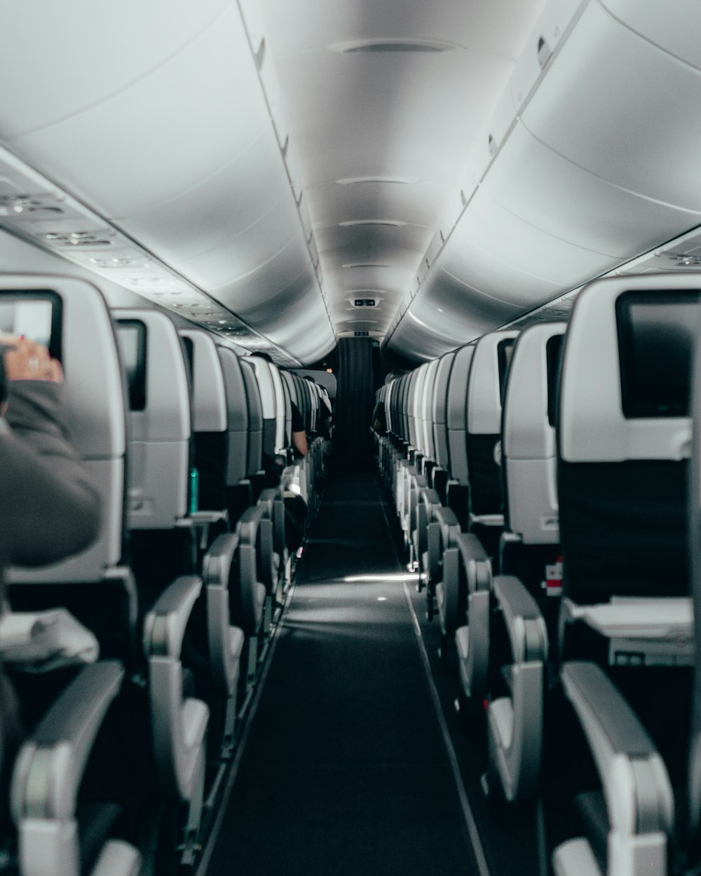 the inside of an airplane with rows of seats