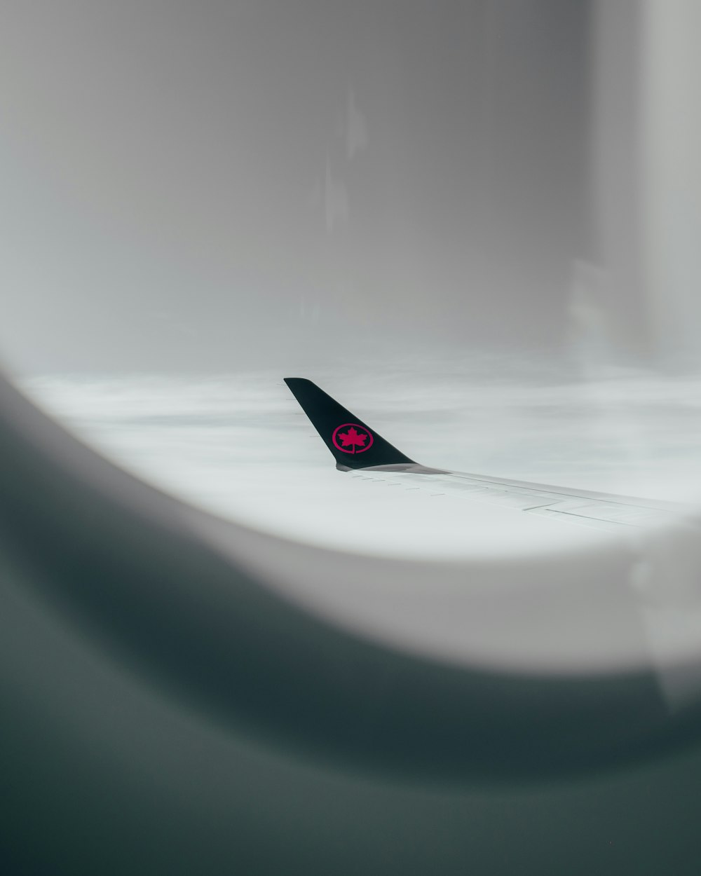 a black and red airplane sitting on top of an airport tarmac