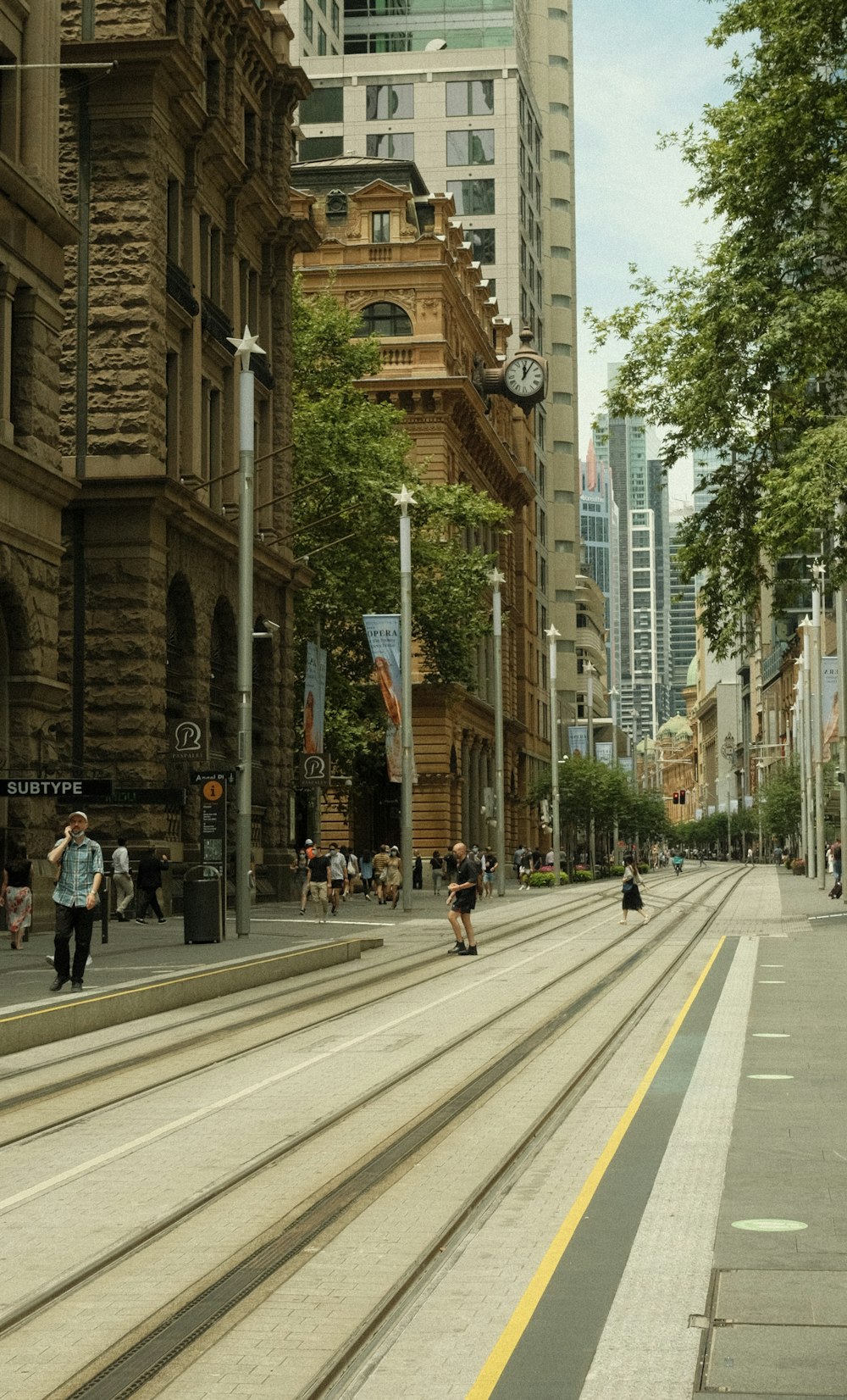 a city street lined with tall buildings and people walking