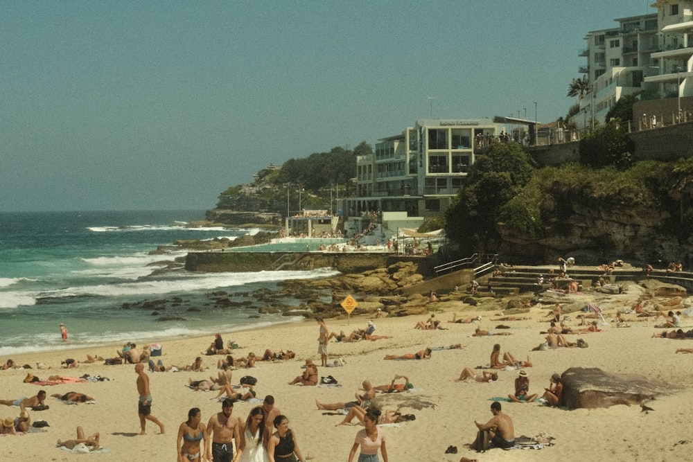 many people are on the beach and in the water