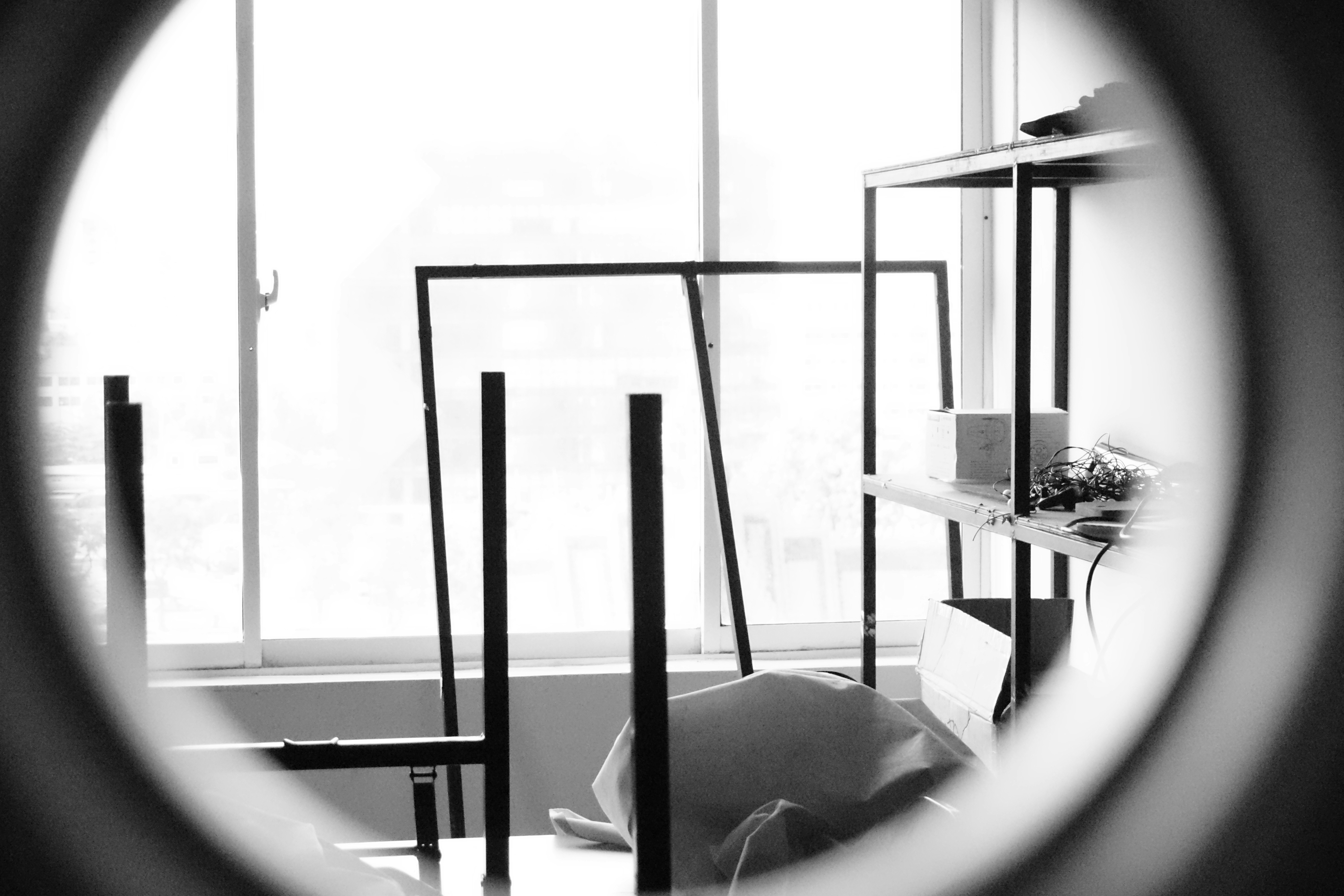 a black and white photo of a room through a magnifying glass