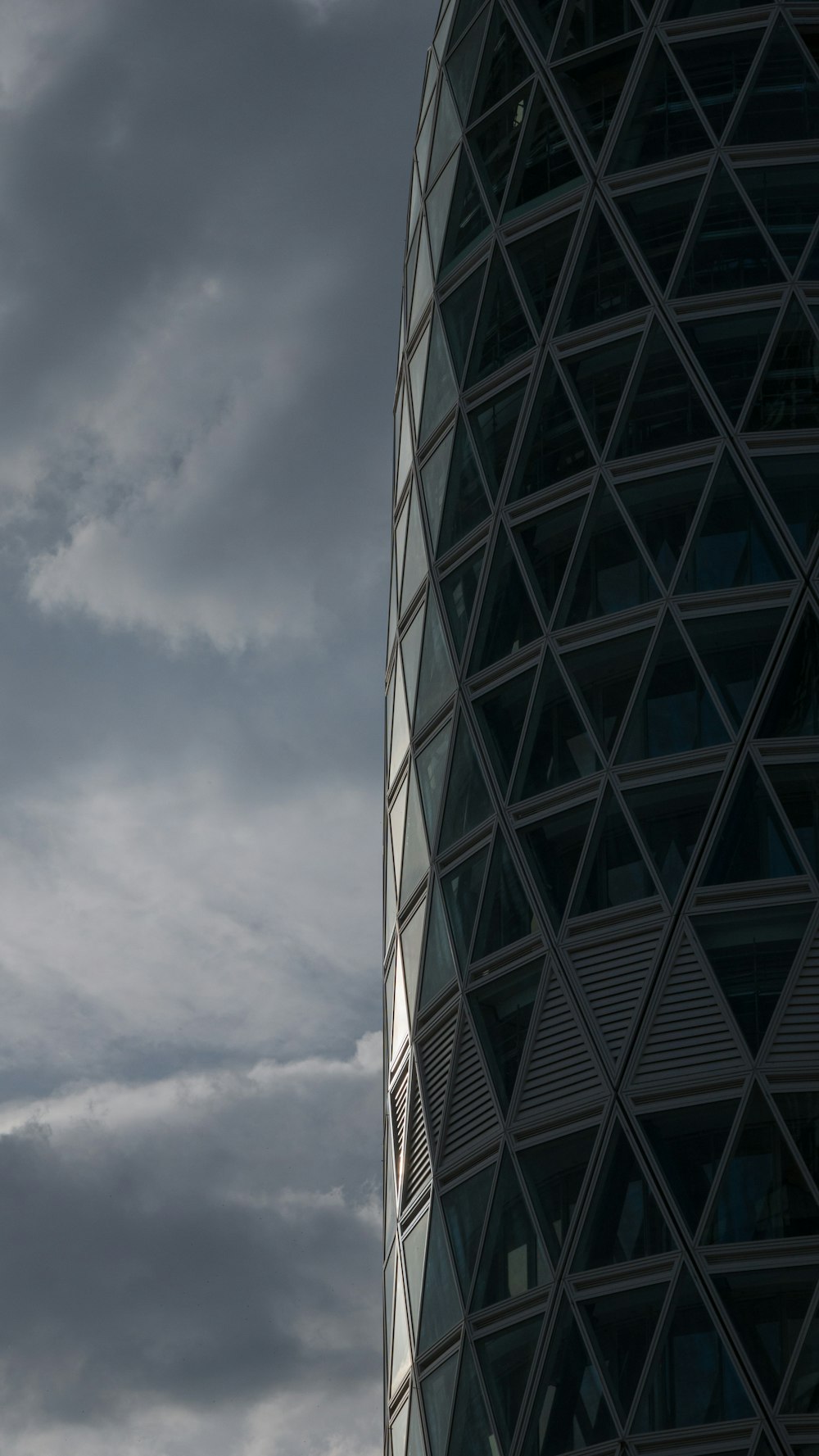 a plane flying in the sky next to a tall building