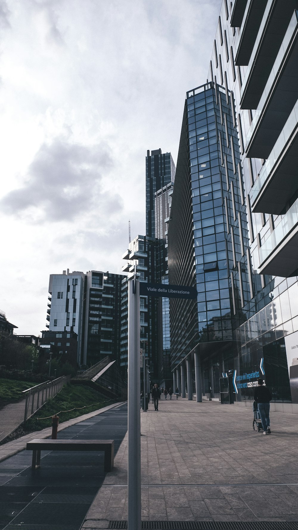 a man riding a bike down a street next to tall buildings