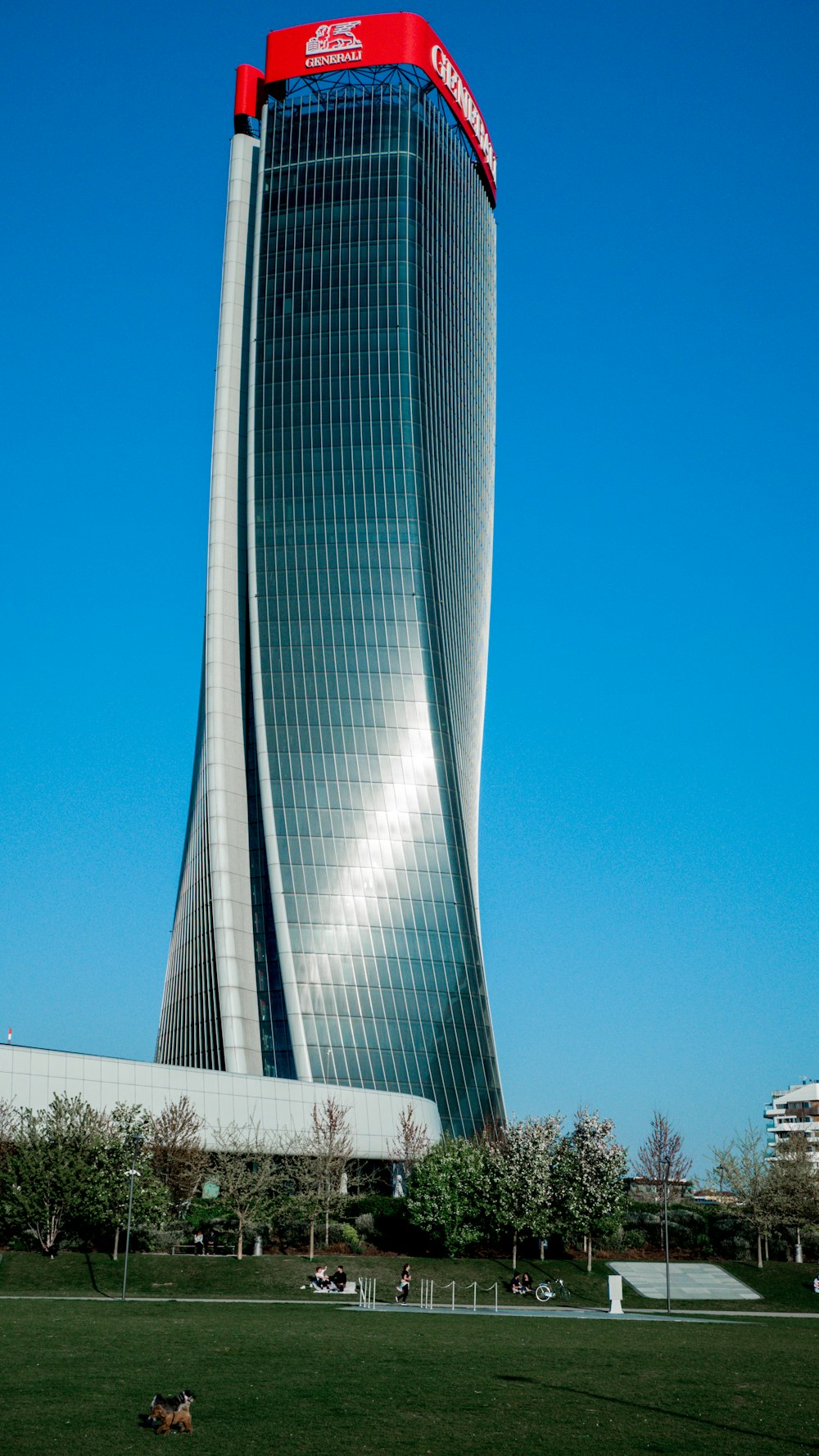 a tall building with a red sign on top of it