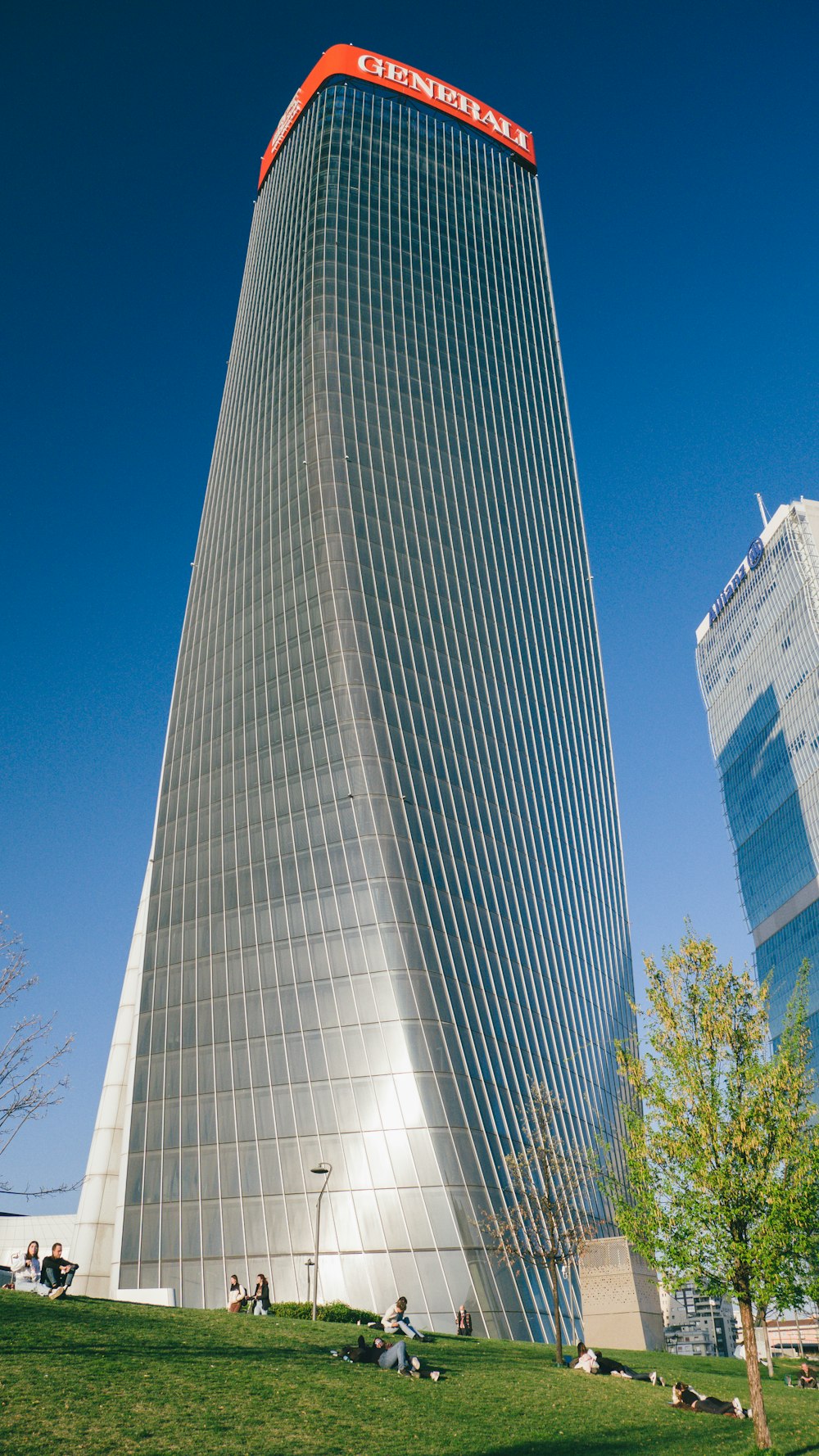 a tall building with a red sign on top of it