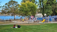 A vibrant community area with children playing and families enjoying the outdoors, highlighting a friendly neighborhood atmosphere.