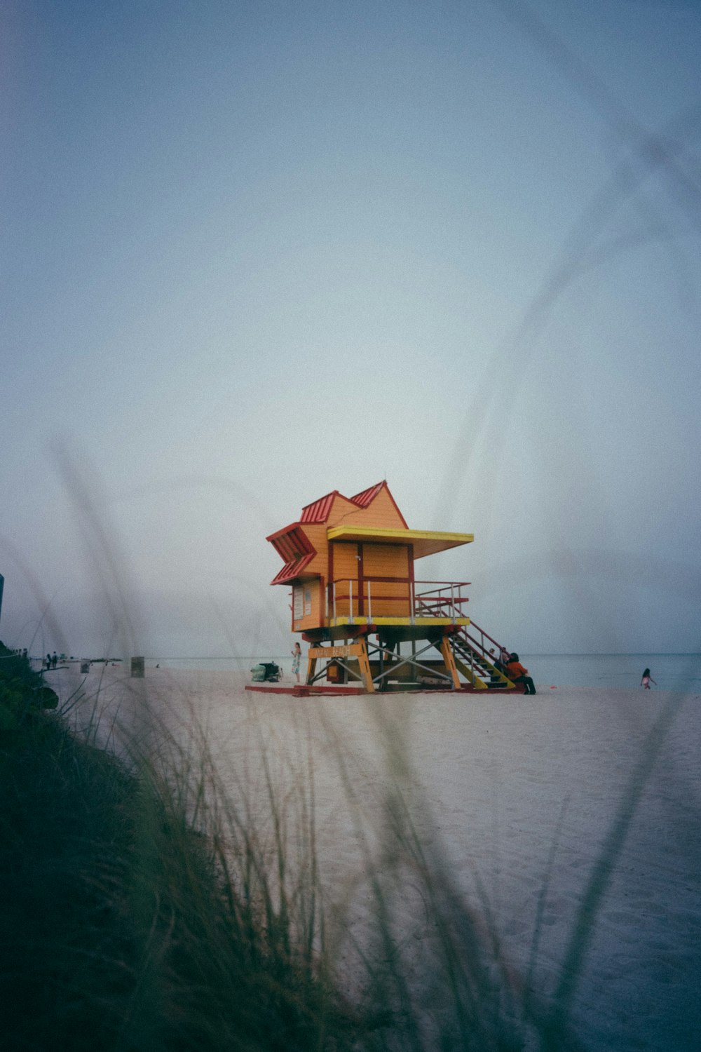 a lifeguard station on a beach with a life guard tower