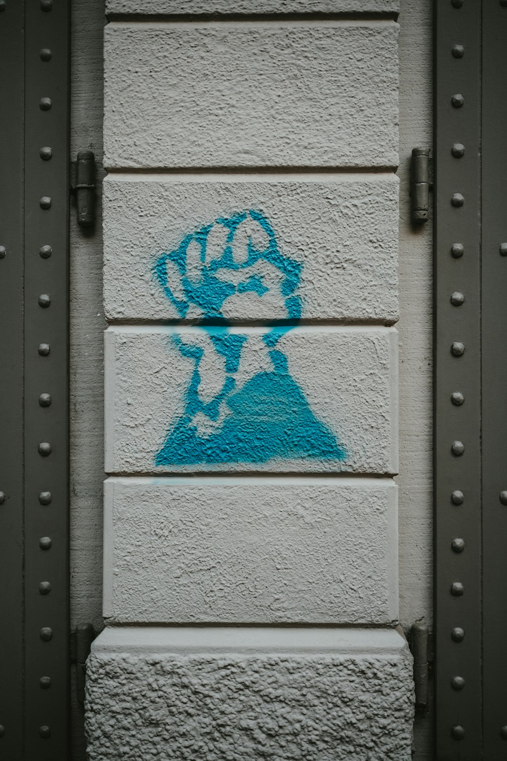 a wall with a blue stencil of a man on it