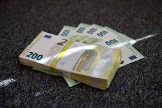 a pile of money sitting on top of a carpet