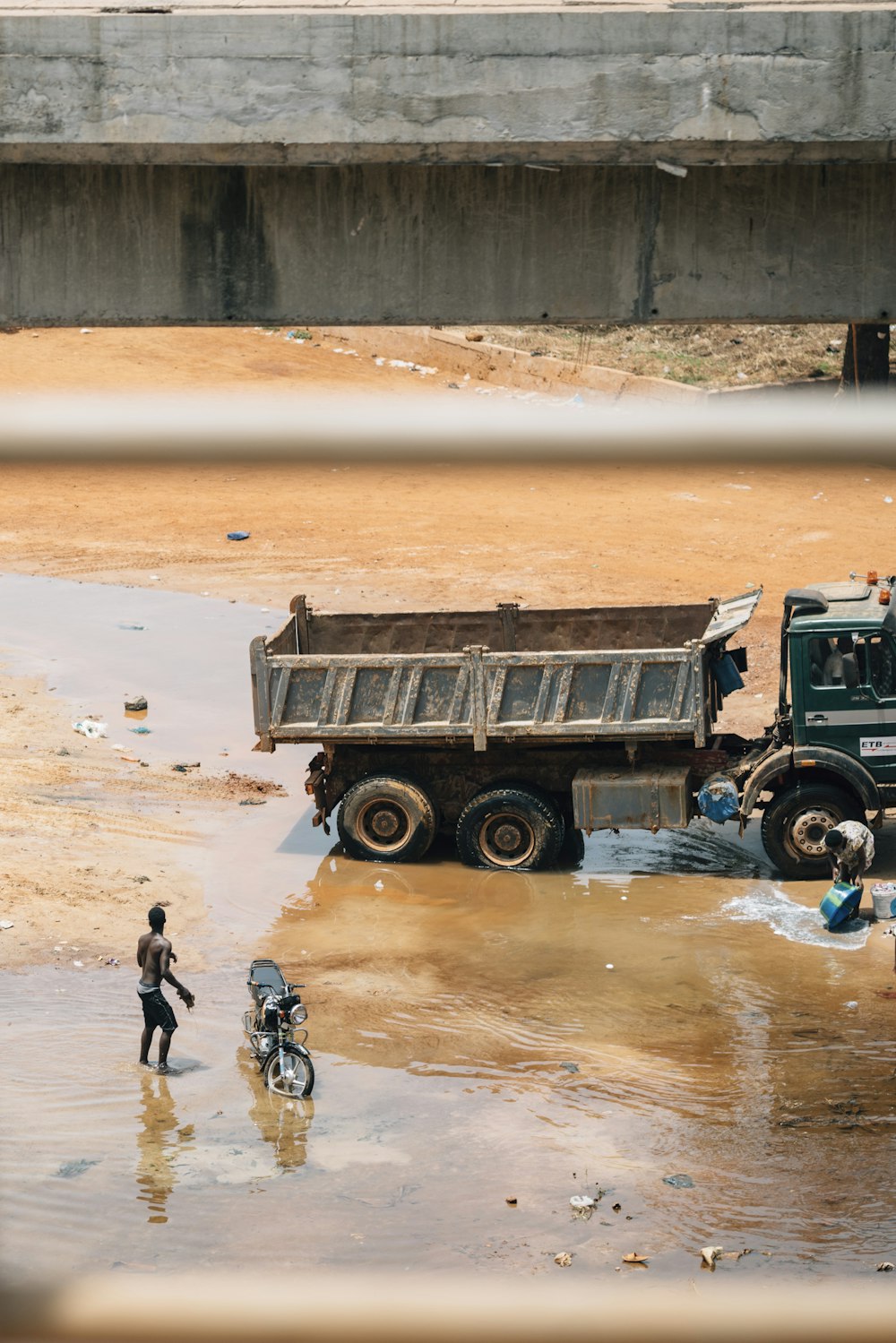 a couple of trucks that are sitting in the mud