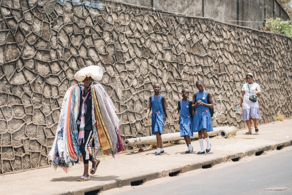 a group of people standing on the side of a road