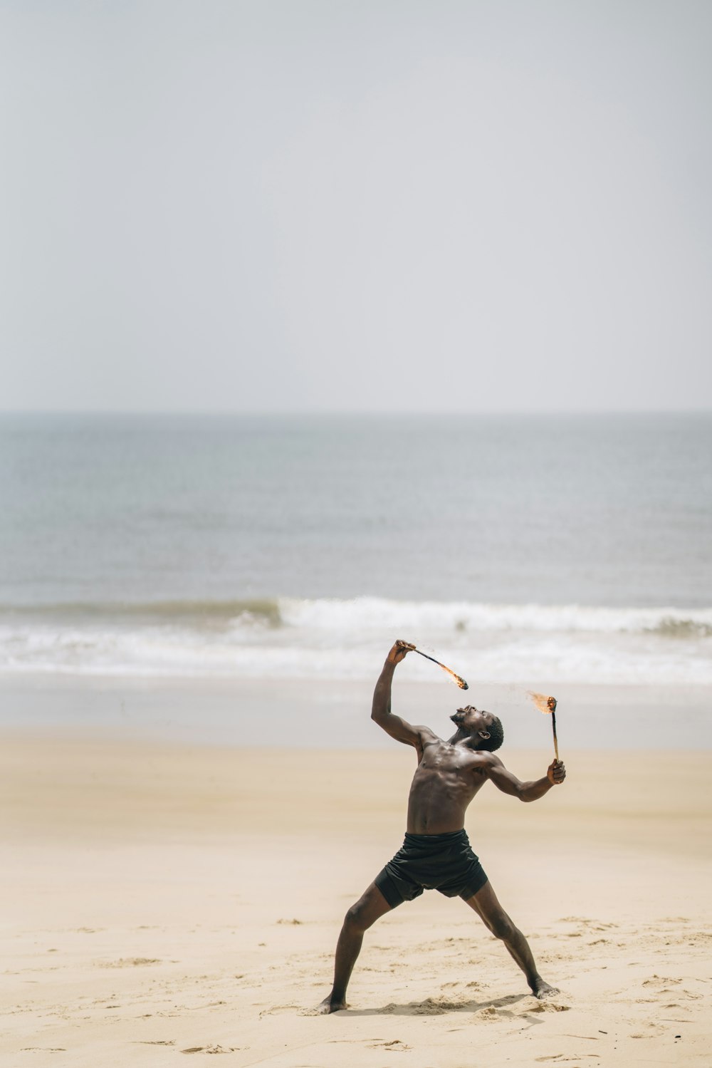 a man standing on top of a sandy beach