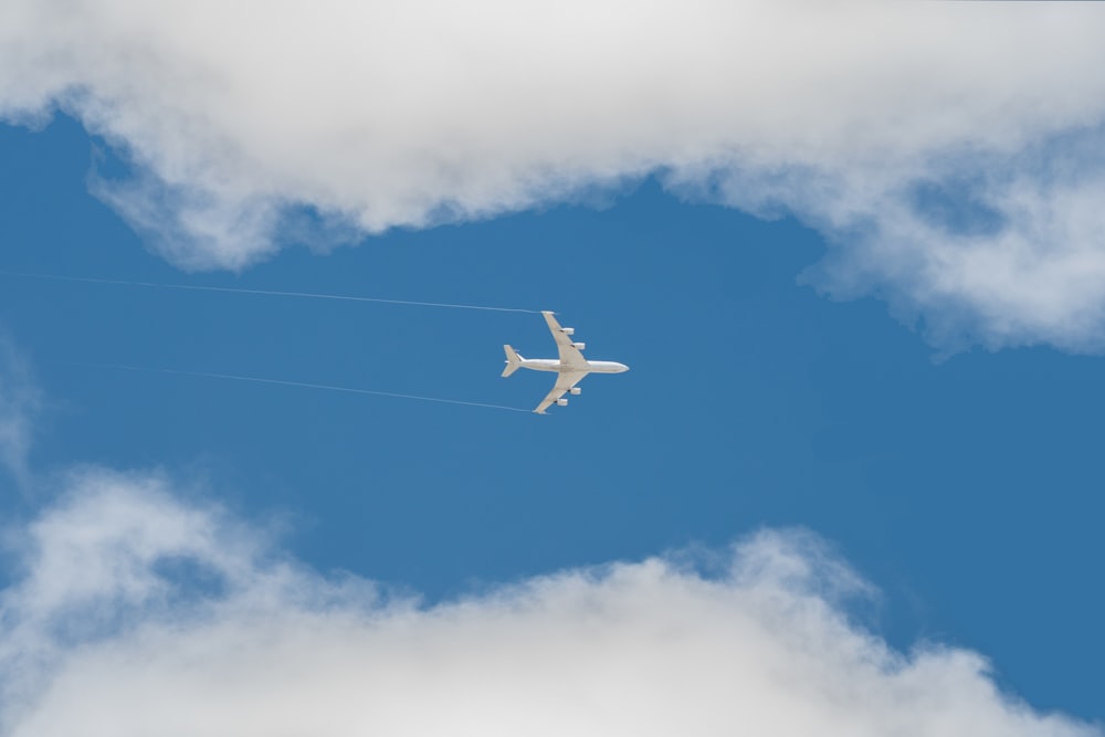 an airplane is flying in the sky on a cloudy day