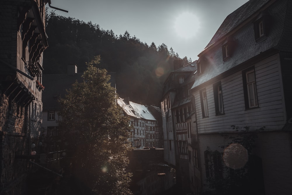 the sun shines through the clouds over a row of buildings