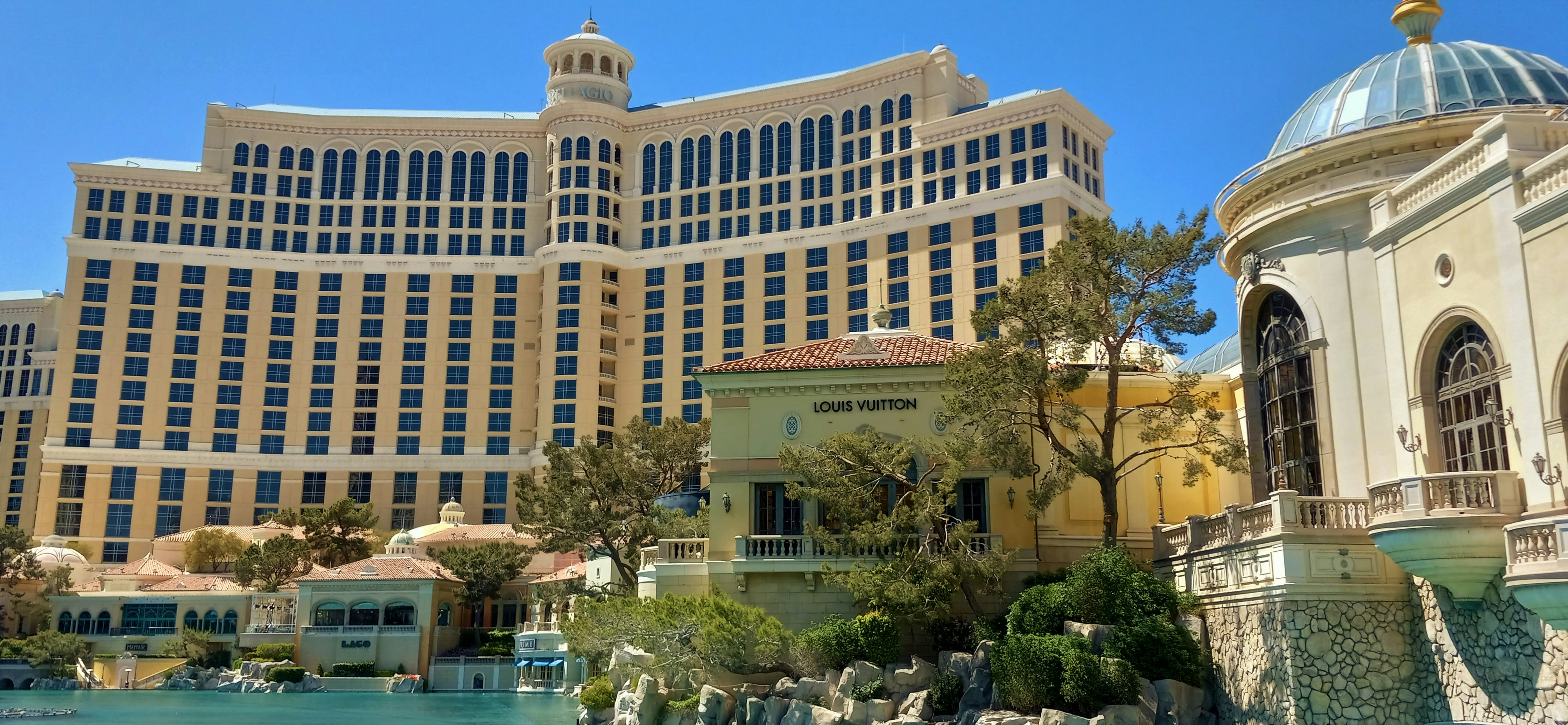 a view of a hotel and a pool in front of it, 