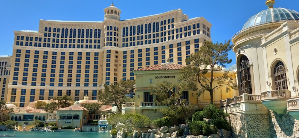 a view of a hotel and a pool in front of it