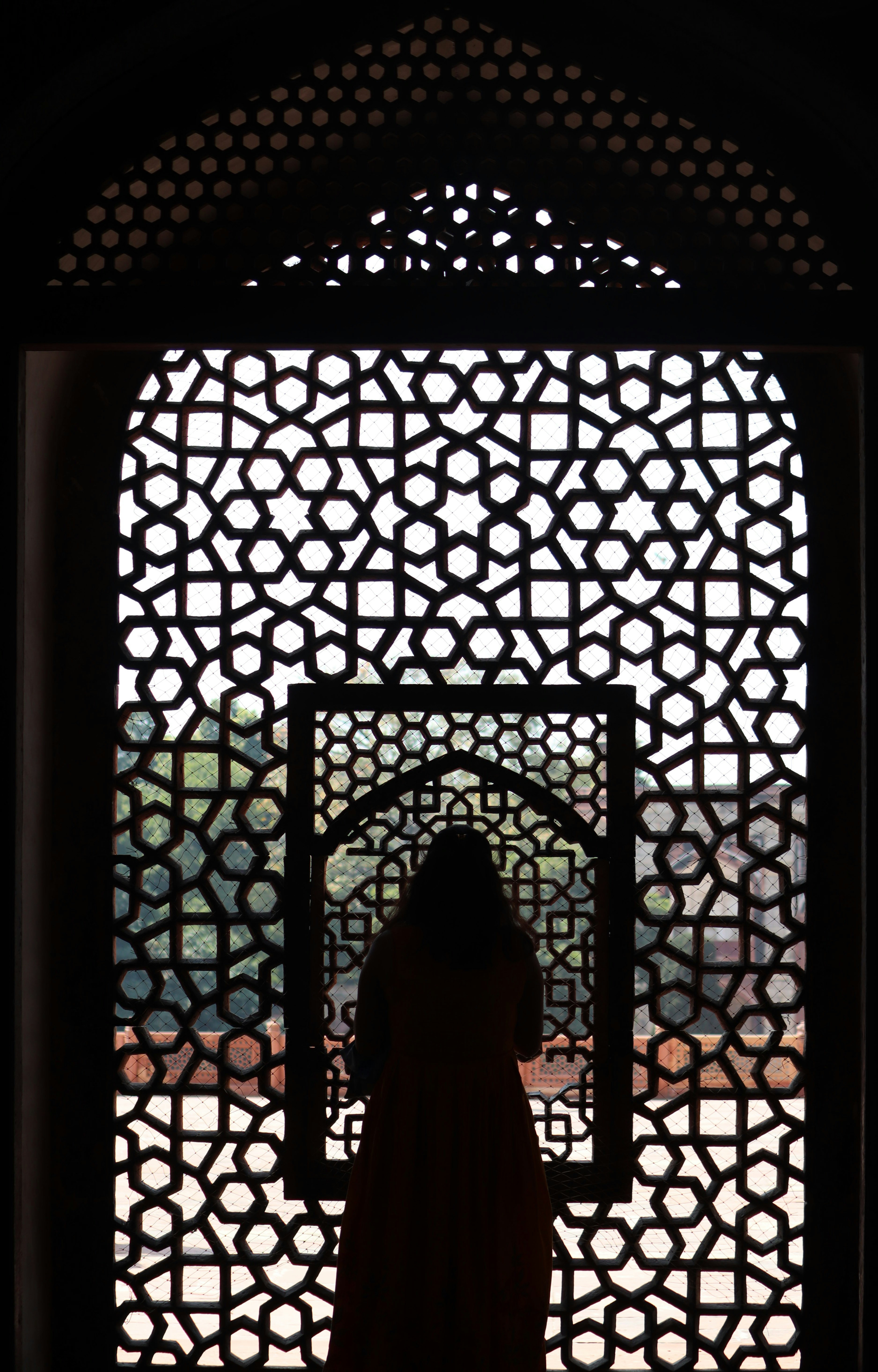 a woman standing in front of a window