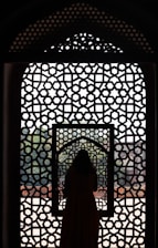 a woman standing in front of a window