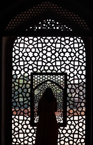 a woman standing in front of a window