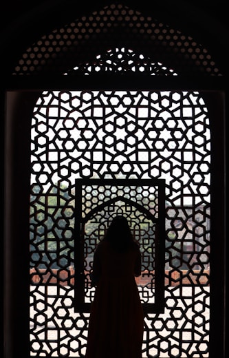 a woman standing in front of a window