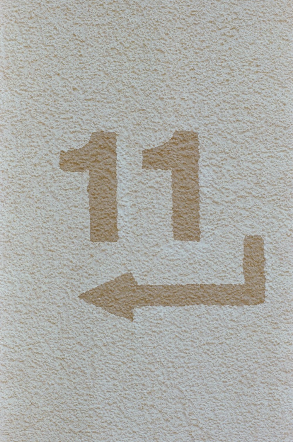 a white towel with a brown arrow drawn on it
