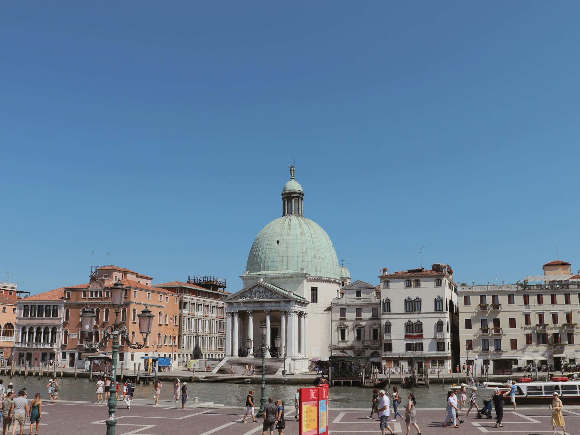 a group of people walking around a city square