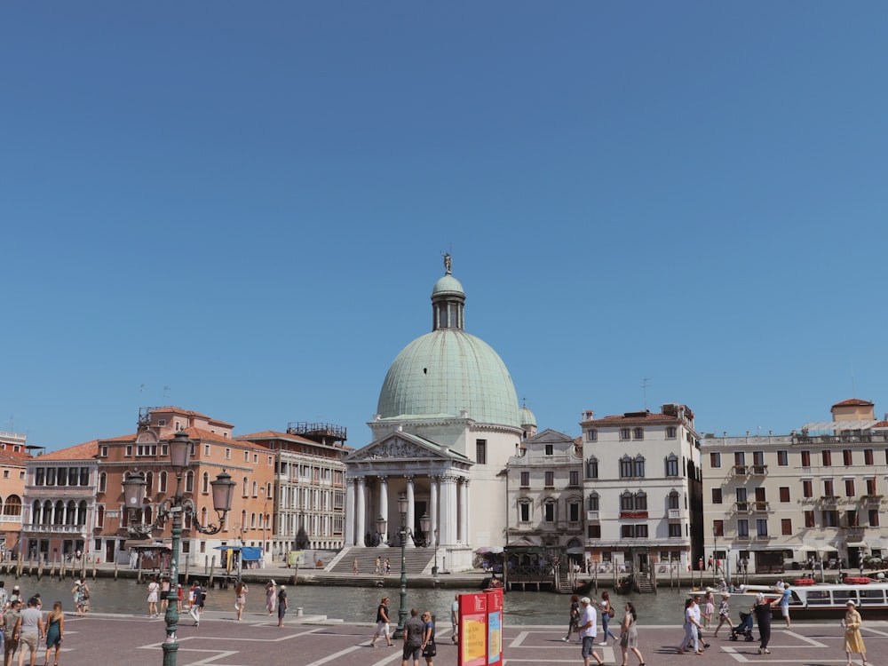 a group of people walking around a city square